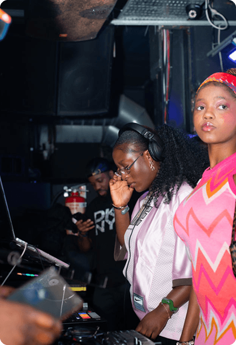 DJ woman with headphones and attendee